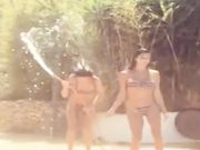 Belen e sua sorella Cecilia giocano con la canna dell acqua in bikini