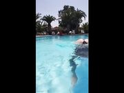 Pompino subacqueo in piscina con guardone